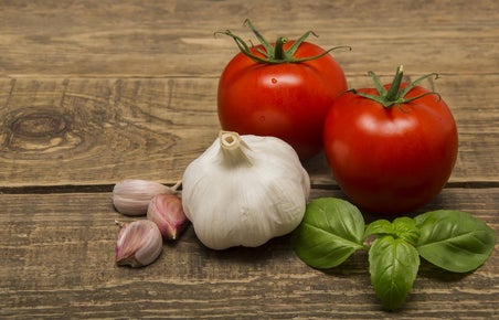 Tomatoes and garlic on a wooden board